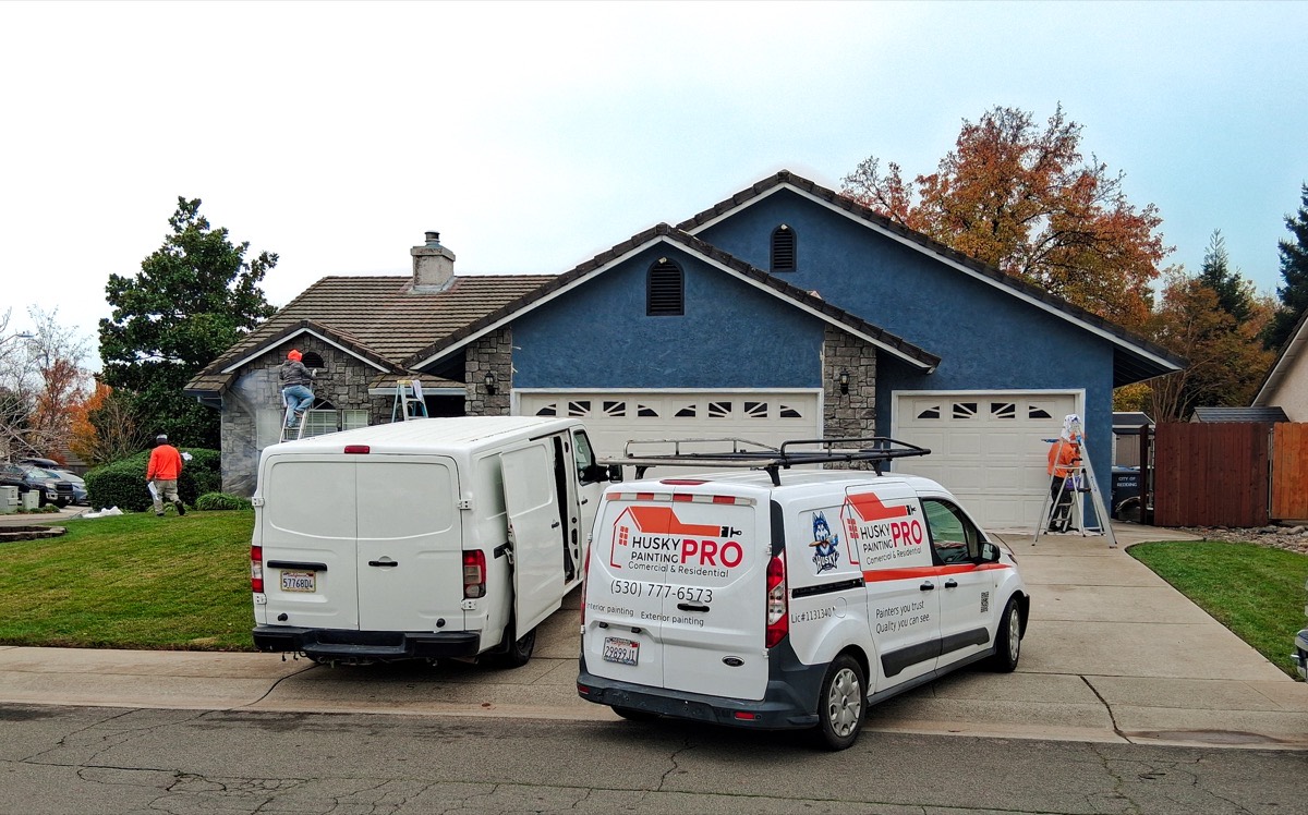 Husky Pro Painting crew and vans at residential job site Northern California