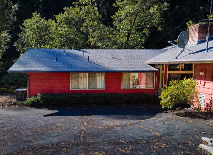 Painter at teal house garage doors Northern California
