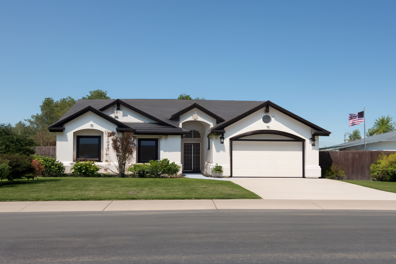 Professionally painted home exterior by Husky Pro Painting in Redding, California — white stucco with dark trim and fresh curb appeal