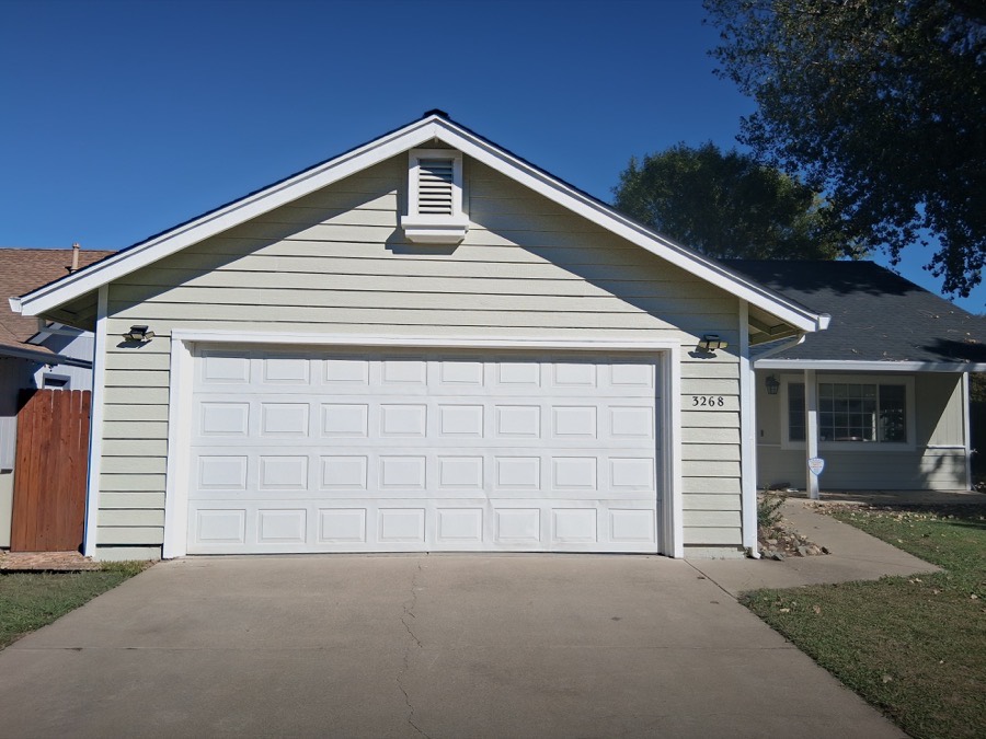 Freshly painted tan house exterior with garage — Husky Pro Painting Redding CA